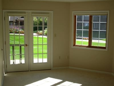 Bright interior space with French doors and grass view