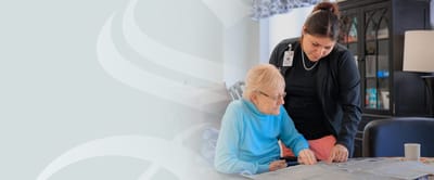 Caregiver assisting a resident with activities.