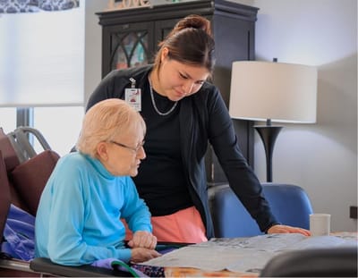 Staff assisting a resident in a common area