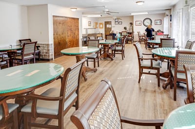 Bright common area with seating and residents interacting