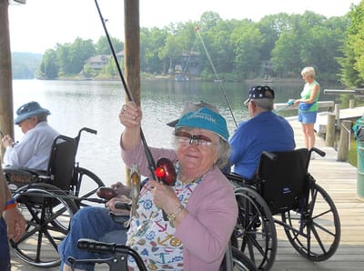 Residents fishing at a lake on a sunny day