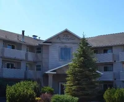 Exterior view of a senior living facility with landscaping