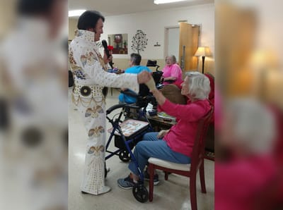 Resident enjoying a performance in the activity room