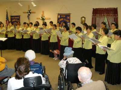 Residents enjoying a choir performance in a common area