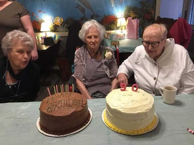 Residents celebrating a birthday with cakes