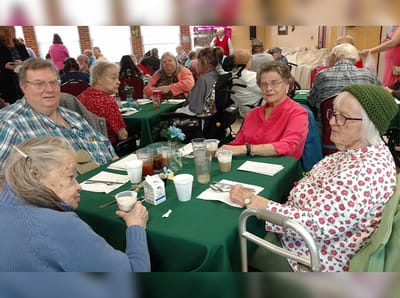 Residents enjoying dining and conversation at a table