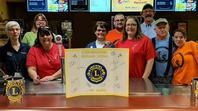 Staff and volunteers at a community event smiling together