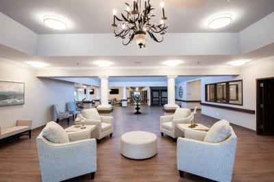 Bright common area with seating and chandelier