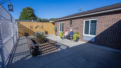 Residents enjoying a sunny outdoor space