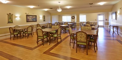 Dining area with tables and chairs in a bright room
