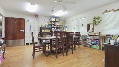 Bright common area with tables and storage