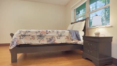 Cozy, well-lit resident room with floral bedding