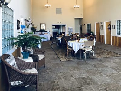Interior view of a community dining area with tables and chairs