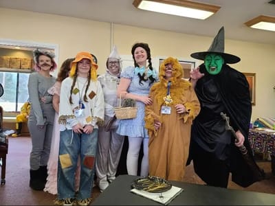 Residents and staff in costumes during a festive event