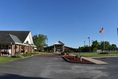 Entrance view of Caremoor Retirement Center with flag