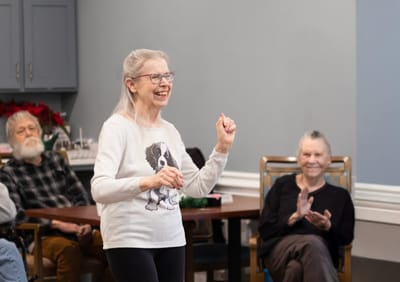 Resident enjoying an activity with others in a common area