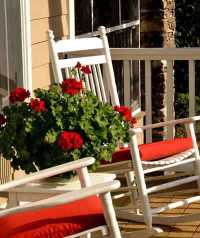 Outdoor porch with rocking chairs and flowers