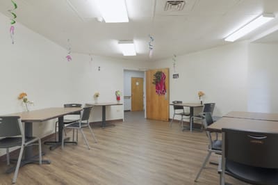 Bright common area with tables and chairs