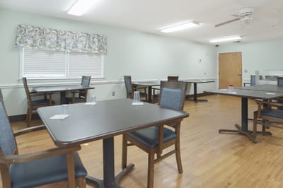 Dining room with tables and chairs in a light setting