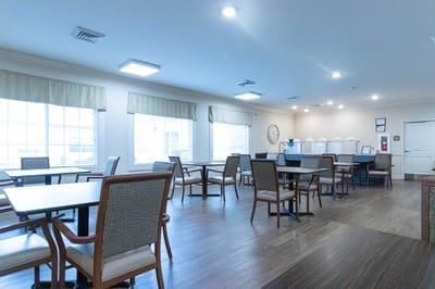 Dining area with tables and chairs in a bright room