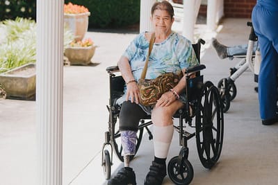 A resident in a wheelchair enjoying time outdoors