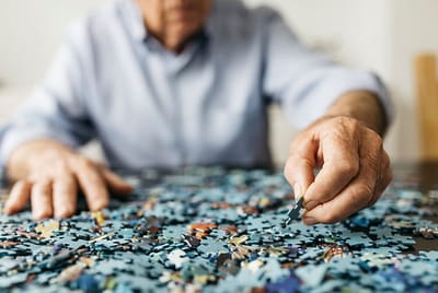 Senior resident engaged in a puzzle activity.