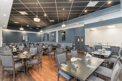 Bright dining room with tables set for meals