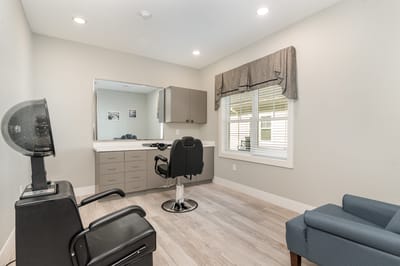 Bright hair salon area with styling chair