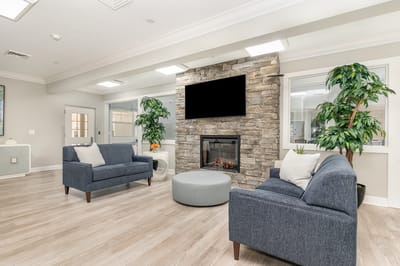 Bright common area with seating and fireplace