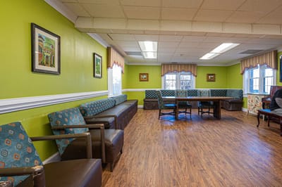 Common area with seating and artwork on green walls