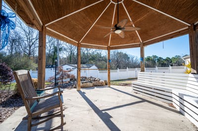 Outdoor gazebo with seating area and garden view