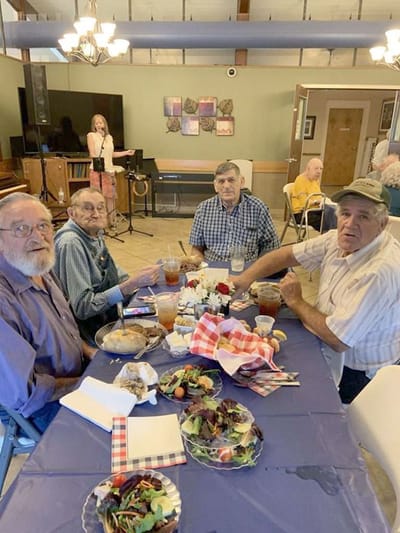 Residents enjoying a meal together in the dining area