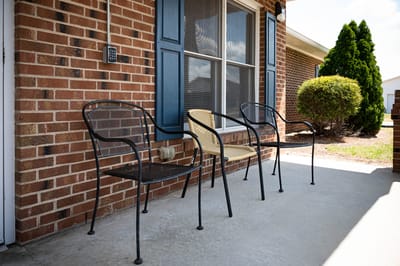 Outdoor seating area with chairs in front of a building