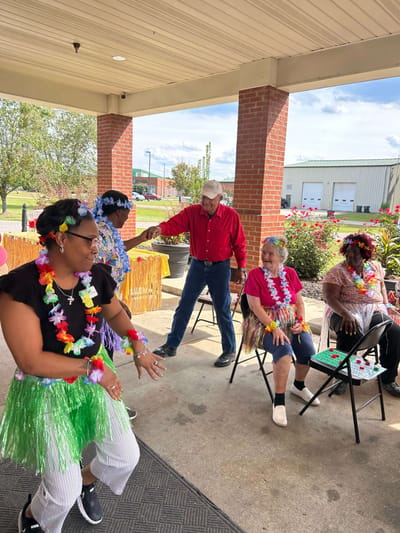 Residents and staff celebrating outdoors in festive attire