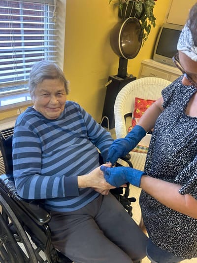 Staff member assisting a resident in a common area.