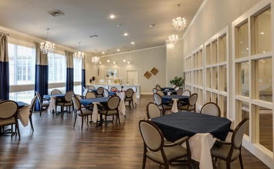 Dining area with tables and chairs in a bright setting