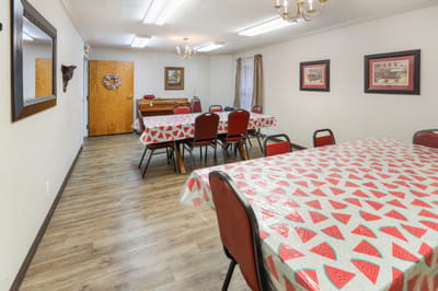 Dining area with tables and chairs set up for meals