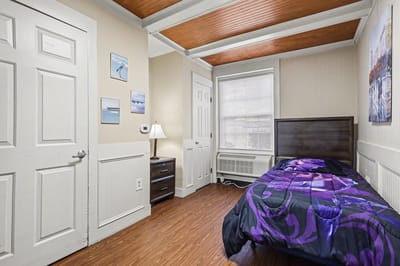 Cozy private bedroom with a bed and nightstand