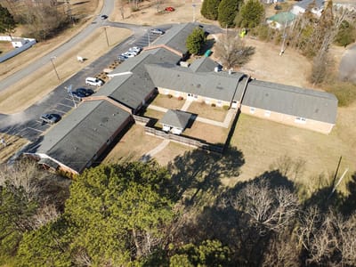 Aerial view of Clayton House facility buildings and parking