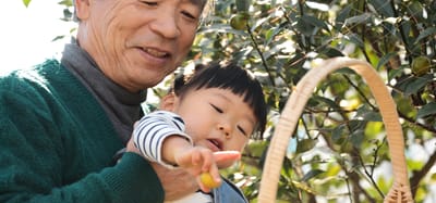 An elderly man and child enjoying a day outdoors.