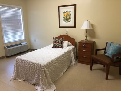 Cozy private room with a bed and artwork