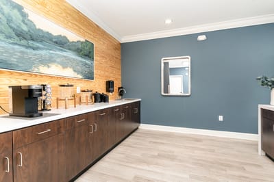 Bright interior space with a coffee station and artwork