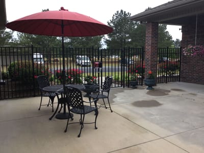 Outdoor seating area with umbrella and flowers