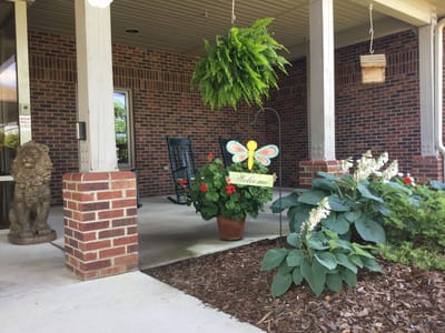Entrance with flowers and a welcome sign