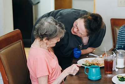 Staff member interacting with a resident during mealtime