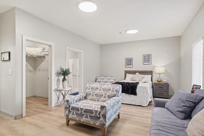 Bright, cozy interior of a resident room showing furniture and decor