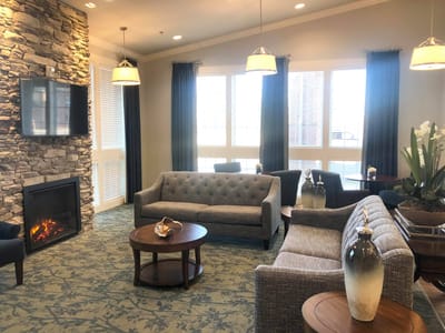 Bright common area with comfortable seating and a fireplace