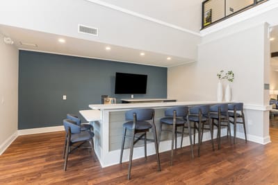 Bright common area with seating and bar counter