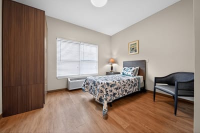 Bright private resident room with floral bedding