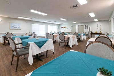 Bright dining room with tables set for meals